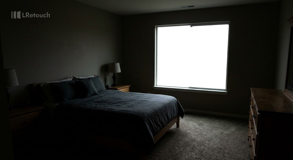 High contrast real estate photo with blown-out windows and dark shadowed interior.