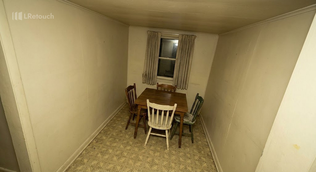 Distorted real estate dining room photo with crooked vertical lines and poor perspective.